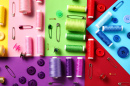 Spools, Buttons and Safety Pins on Colored Background